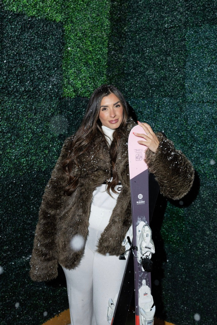 Woman wearing Buffalo Heiress Faux Fur Coat in rich chocolate brown with toggle closures and embroidered back design