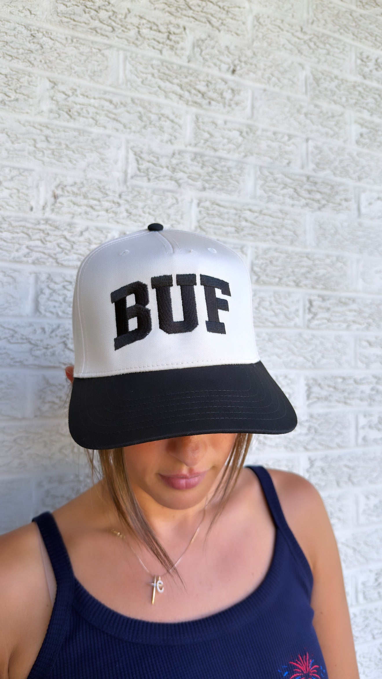 Buffalo blackout hat with bold black embroidery on beige and black trucker style, adjustable fit with BUF and BAL details