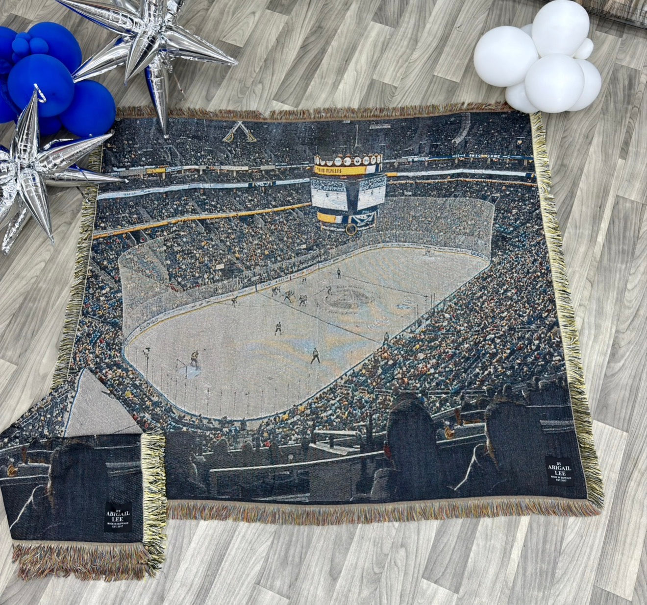 Buffalo tapestry blanket featuring woven material and hand-sewn corner patches celebrating hockey playoffs