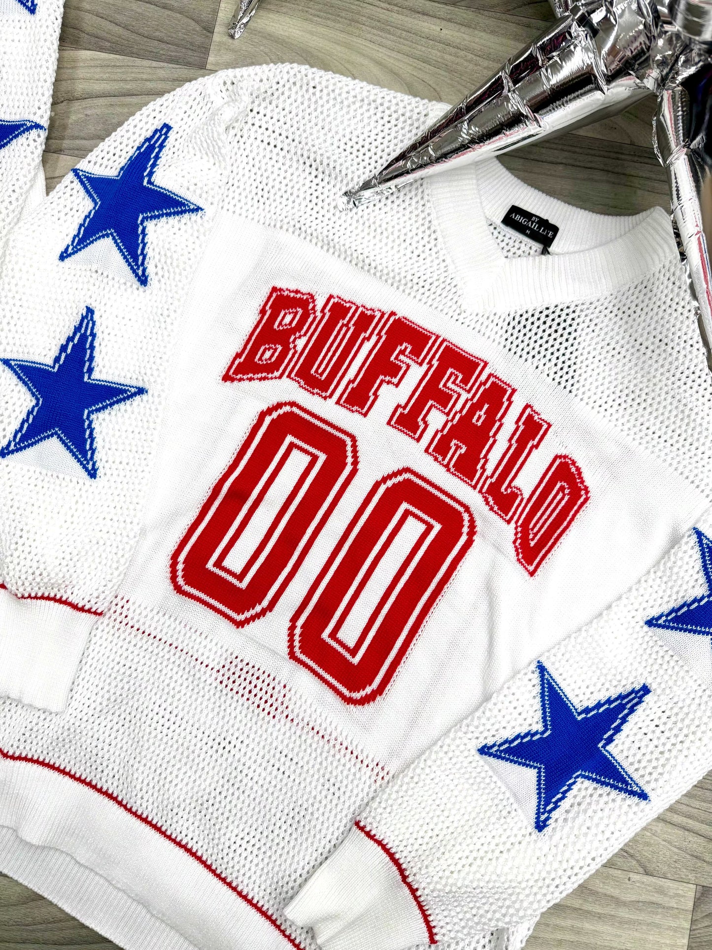 Buffalo football knit sweater close up showing beaded star sleeve detail