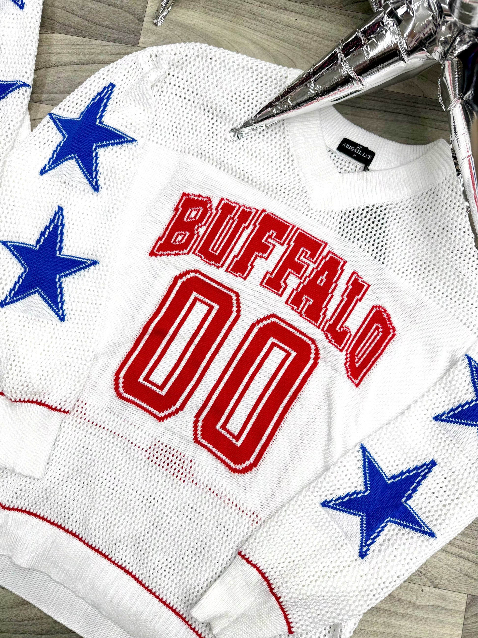 Buffalo football knit sweater close up showing beaded star sleeve detail