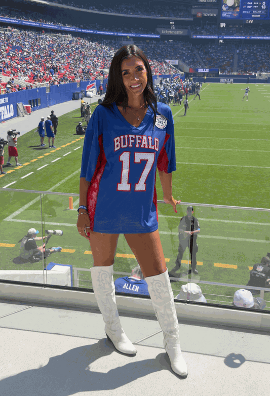 Women wearing oversized lace/mesh jersey with Season One patch at Buffalo stadium event